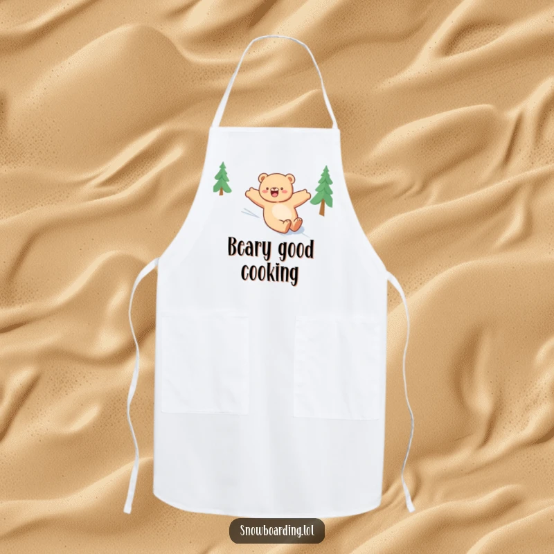 Funny bear apron, happily sliding down a snowy slope with arms outstretched, a humorous and joyful kitchen accessory.